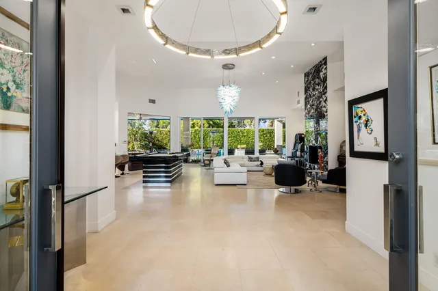 a living room with furniture or chandelier and a wooden floor