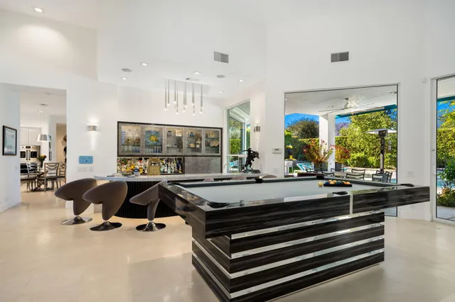 a living room with furniture a fireplace and a large window