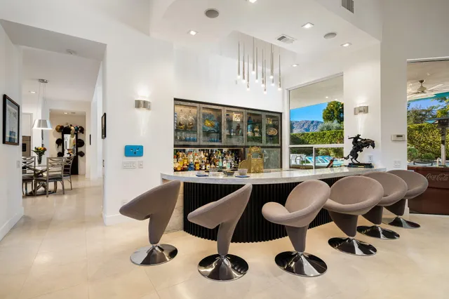 a kitchen with stainless steel appliances kitchen island granite countertop a stove and a refrigerator