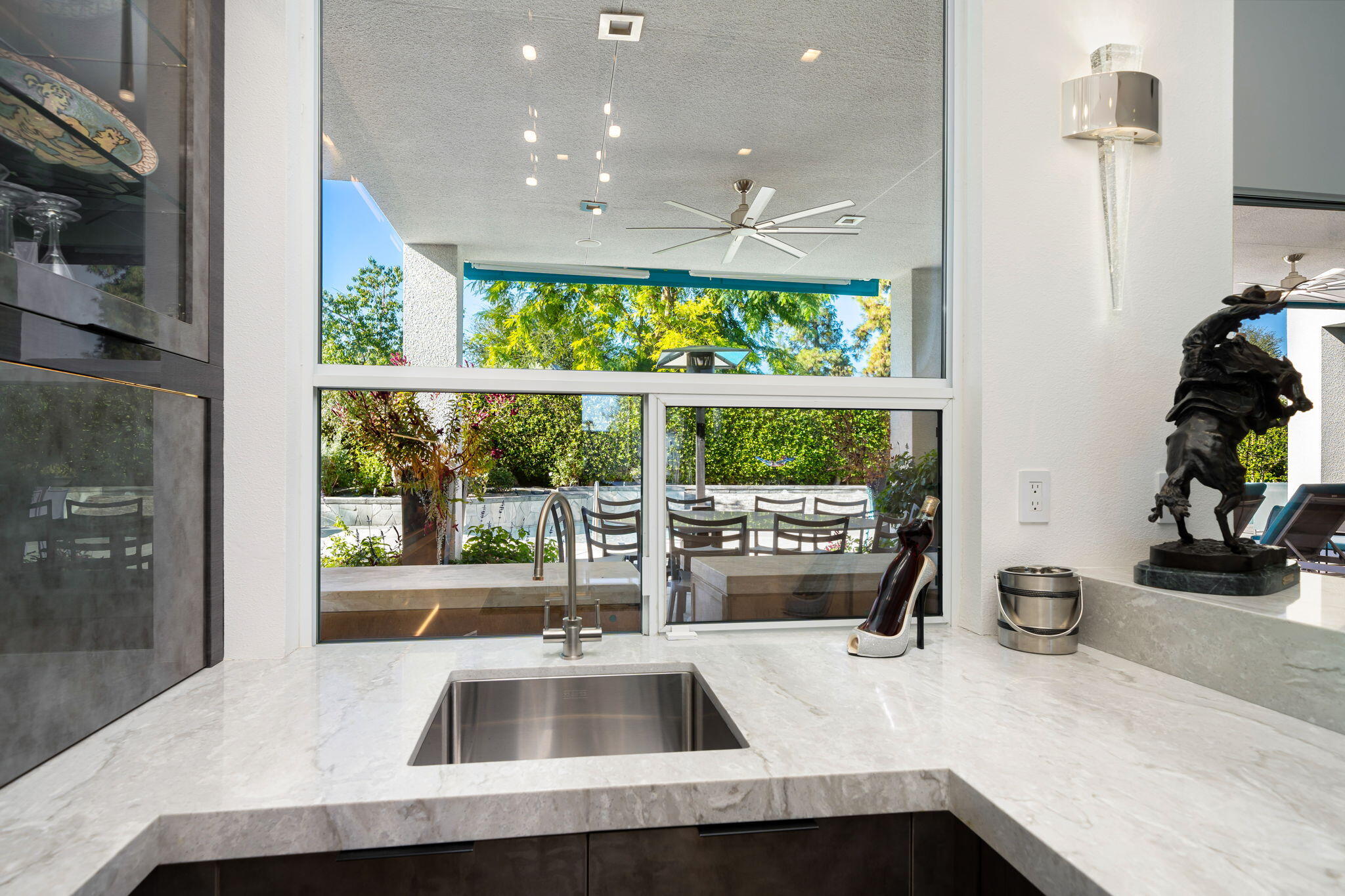 105 Waterford Circle Rancho Mirage, CA 92270 - Photo 28 of 76 a kitchen with a sink a counter top space and a large window