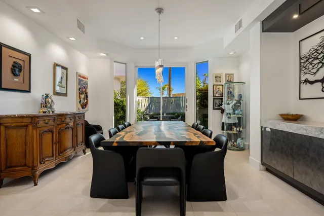 a kitchen with stainless steel appliances kitchen island granite countertop a stove and a sink