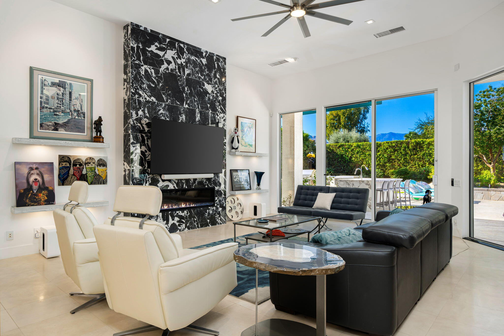 105 Waterford Circle Rancho Mirage, CA 92270 - Photo 33 of 76 a living room with furniture a fireplace and a large window
