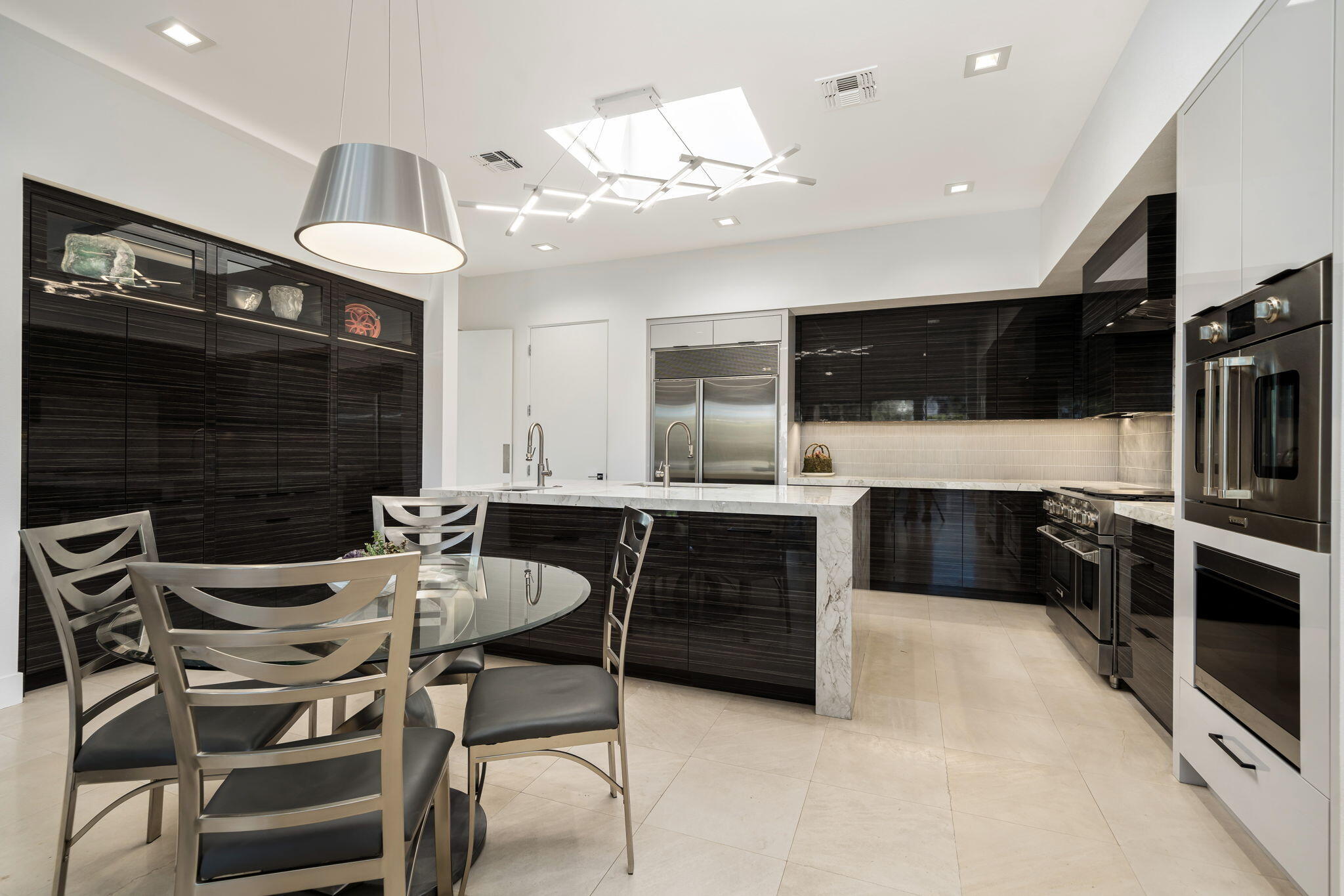105 Waterford Circle Rancho Mirage, CA 92270 - Photo 38 of 76 a kitchen with stainless steel appliances kitchen island granite countertop a sink and a stove