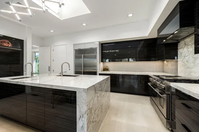 a view of a patio with table and chairs potted plants and palm tree