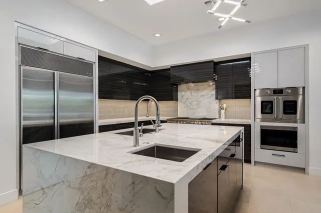 a view of a patio with couches table and chairs potted plants and palm tree
