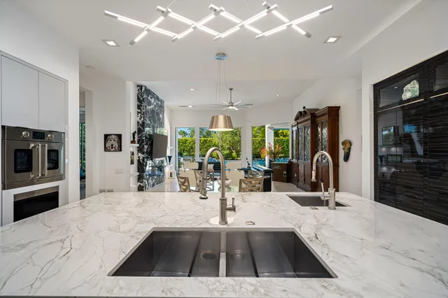 a bedroom with a bed a flat screen tv and a large window