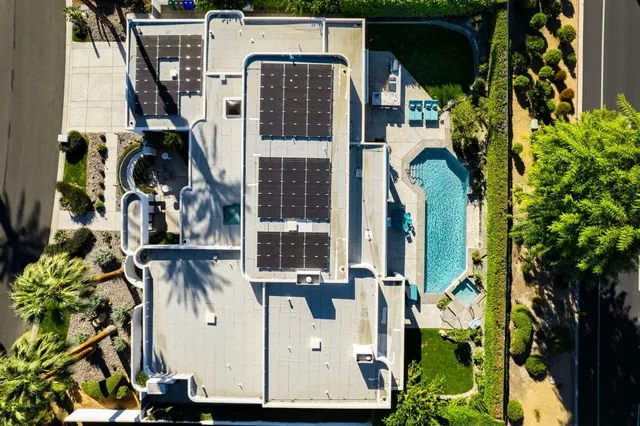 a view of a house with a yard and garden