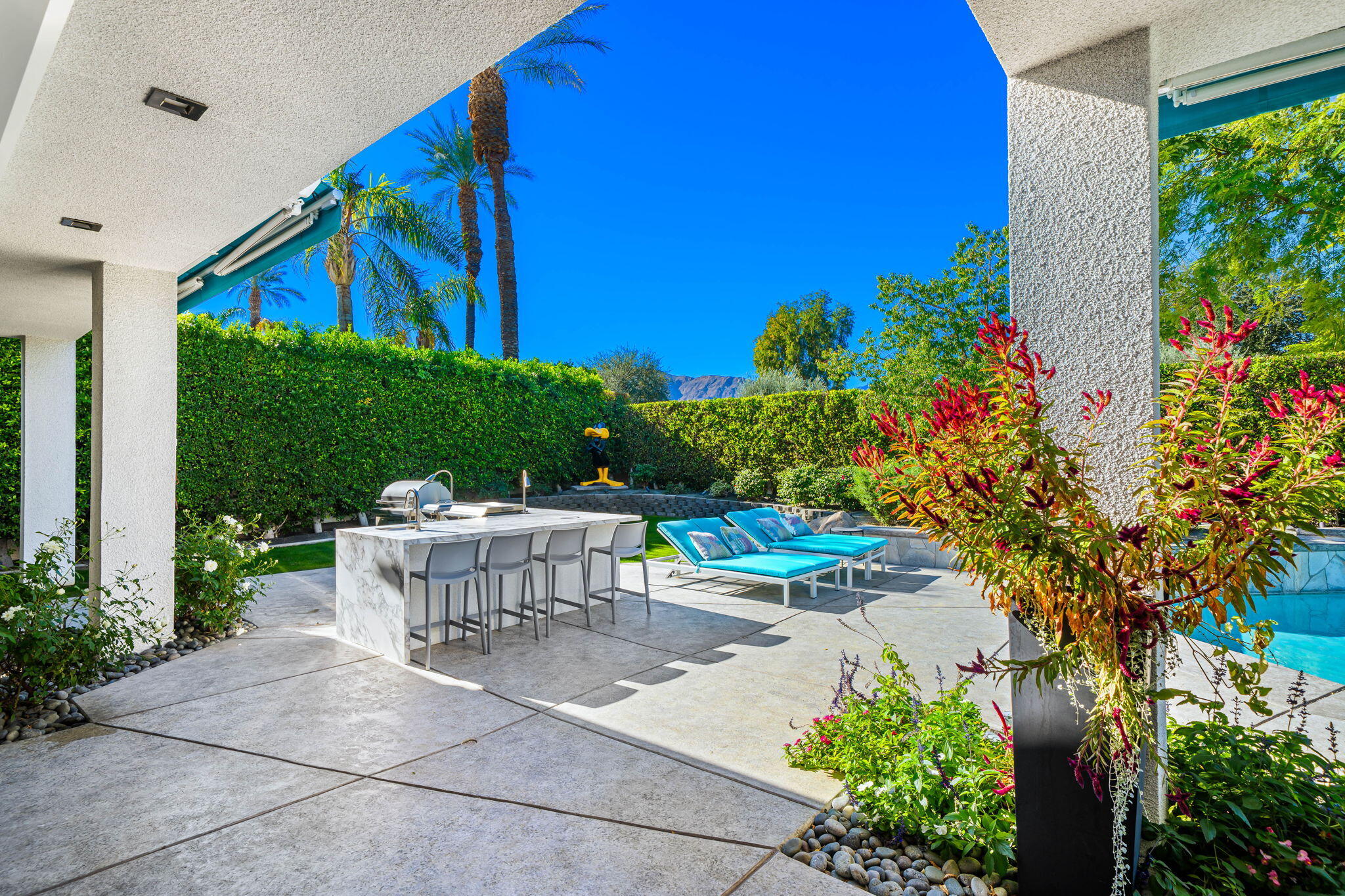 105 Waterford Circle Rancho Mirage, CA 92270 - Photo 51 of 76 a view of a patio with table and chairs potted plants