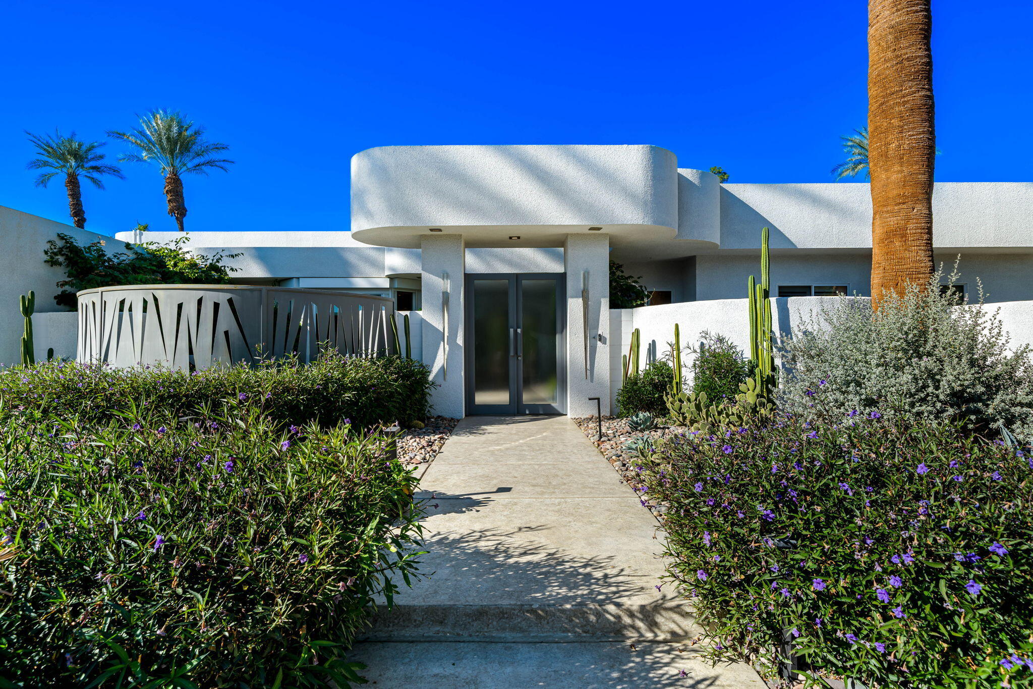 105 Waterford Circle Rancho Mirage, CA 92270 - Photo 10 of 76 a view of a house with a yard and potted plants