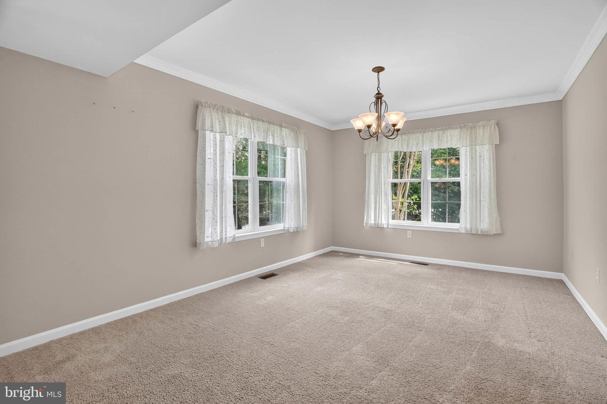 1749 Maple Avenue Hanover, MD 21076 - Photo 11 of 41 an empty room with windows and chandelier