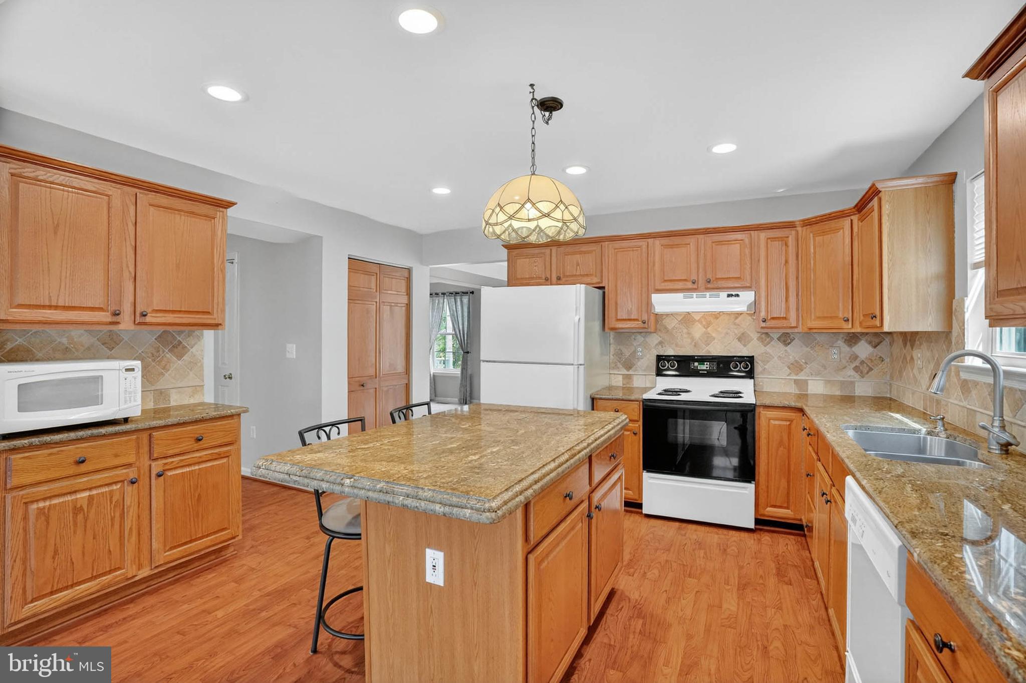 1749 Maple Avenue Hanover, MD 21076 - Photo 15 of 41 a kitchen with granite countertop a sink stove and refrigerator