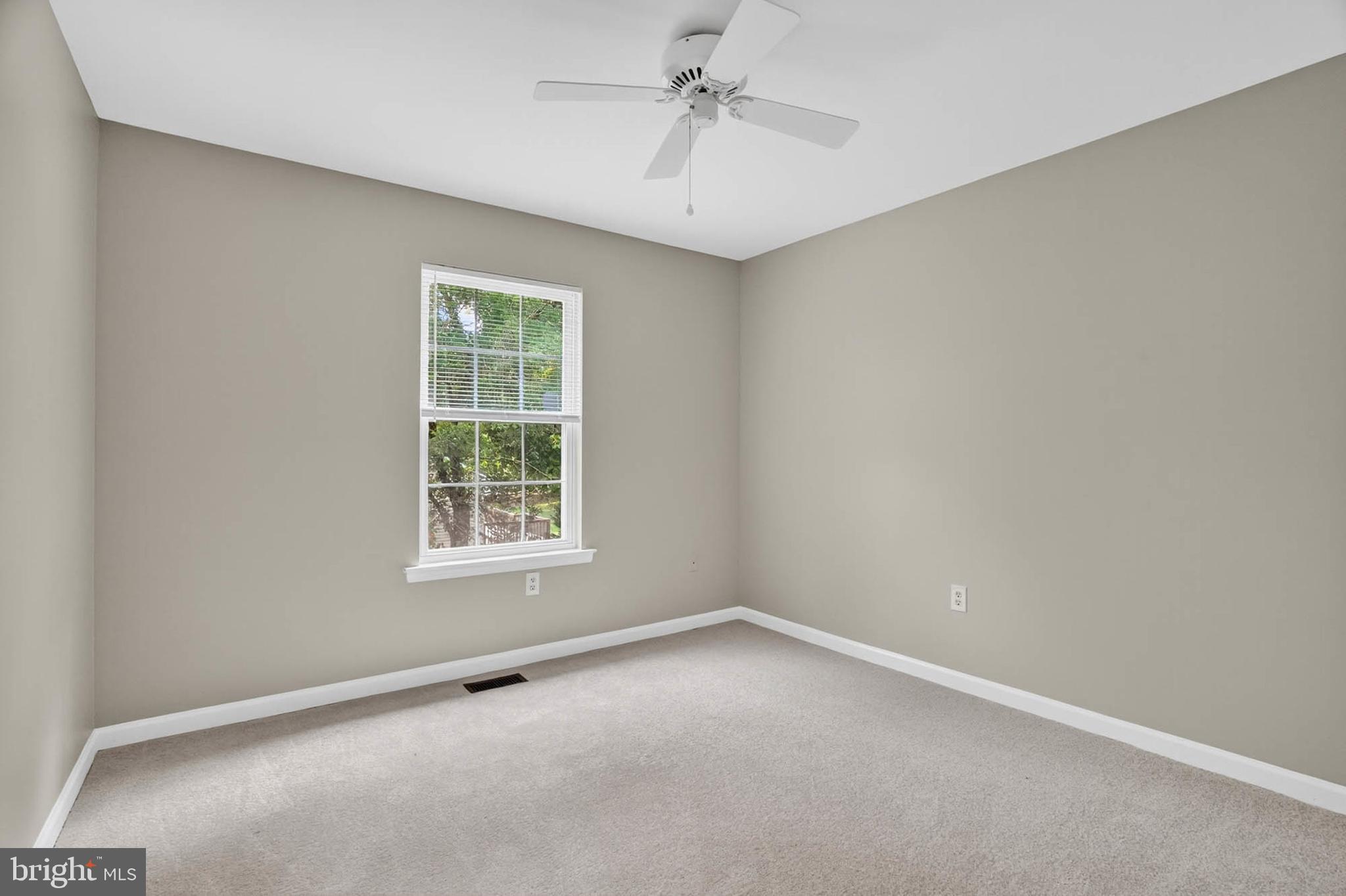 1749 Maple Avenue Hanover, MD 21076 - Photo 29 of 41 an empty room with a window and a ceiling fan