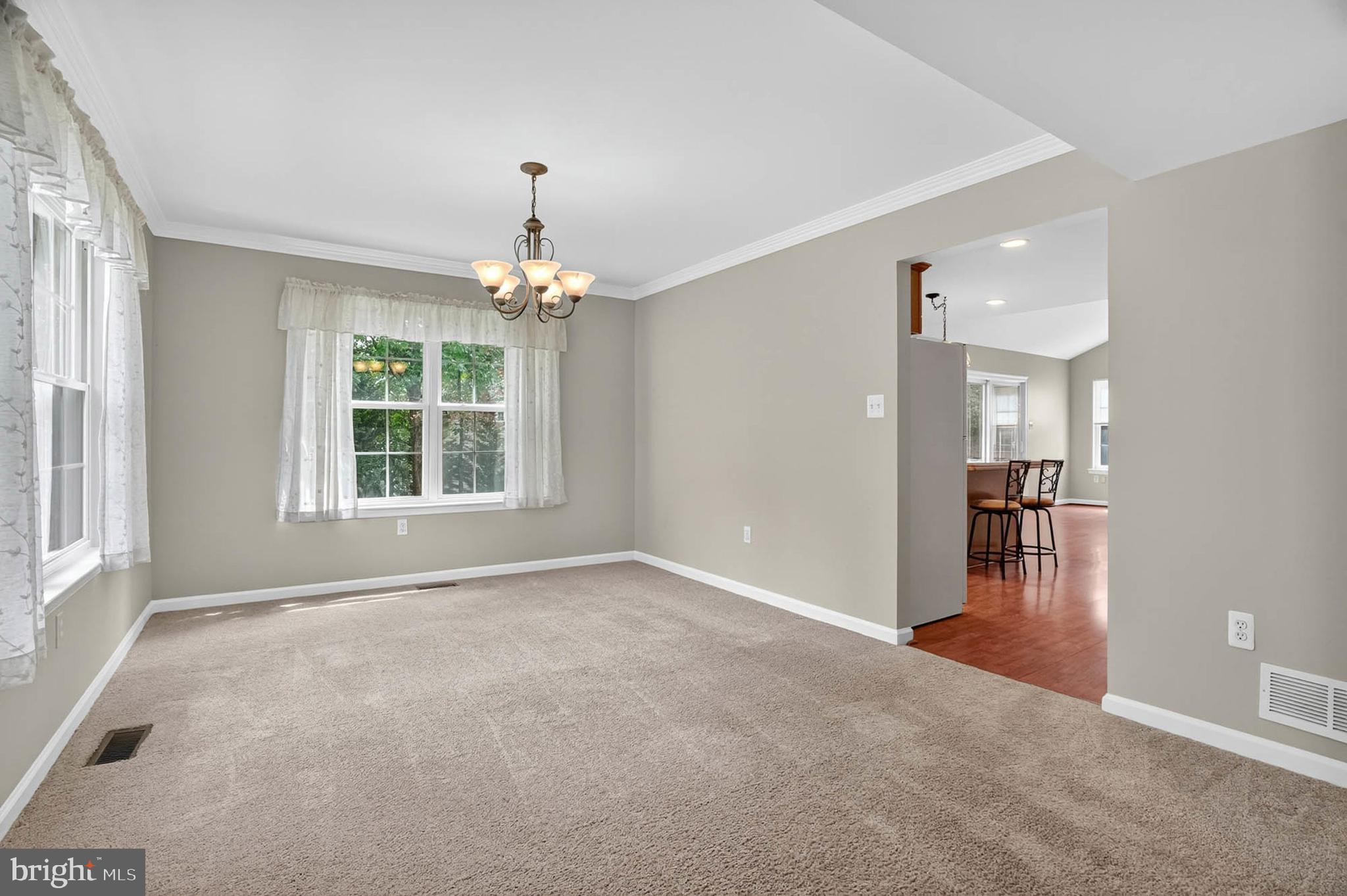 1749 Maple Avenue Hanover, MD 21076 - Photo 10 of 41 an empty room with chandelier and wooden floor