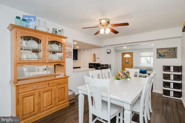 a kitchen with granite countertop wooden cabinets and refrigerator