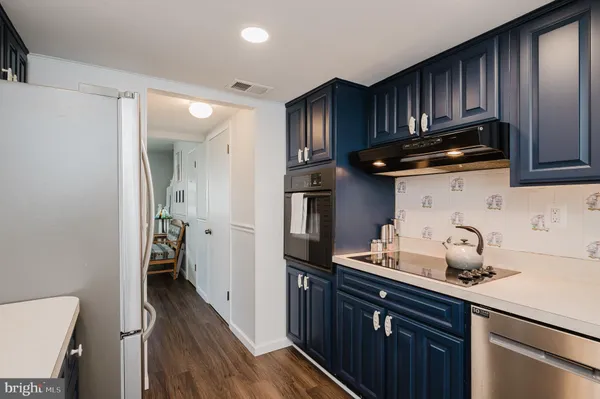 a kitchen with stainless steel appliances a sink and a refrigerator