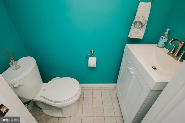 a living room with furniture and a dining table with wooden floor