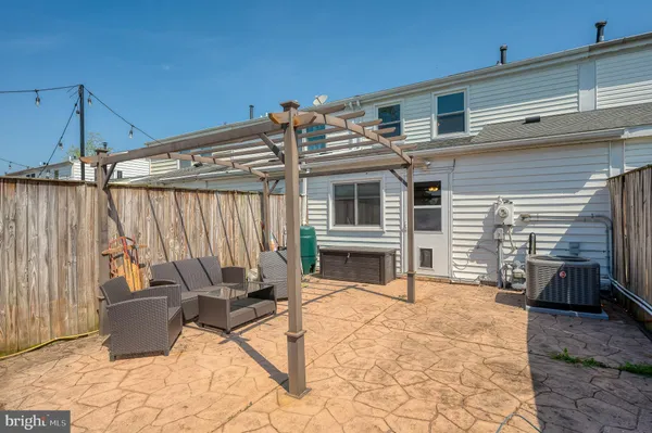 a view of a house with a yard and sitting area