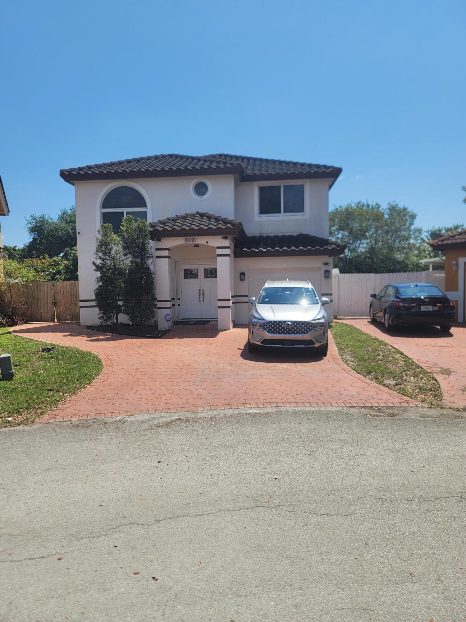 8448 Northwest 196th Terrace Hialeah, FL 33015 - Photo 1 of 67 a front view of a house with a yard