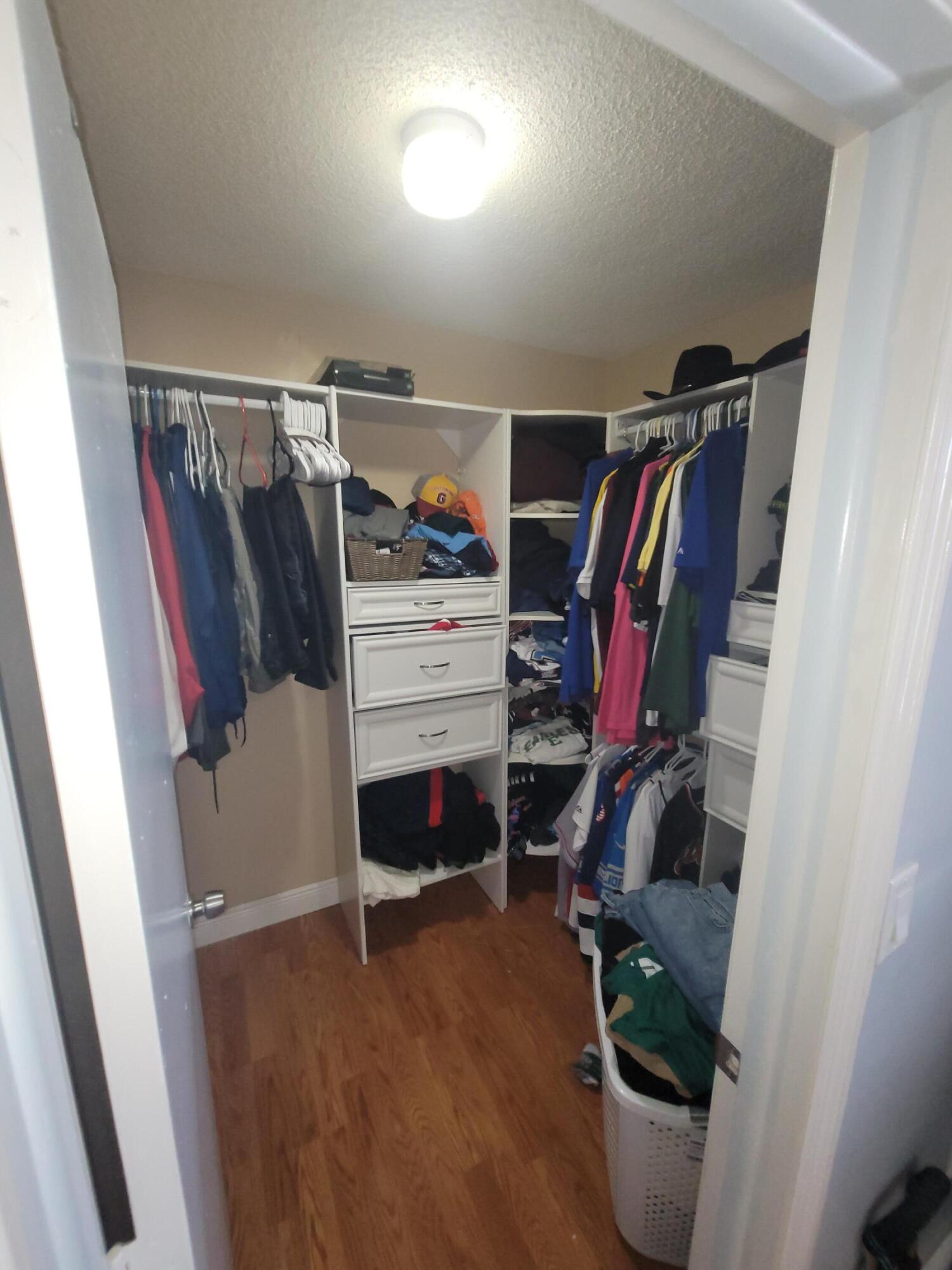 8448 Northwest 196th Terrace Hialeah, FL 33015 - Photo 16 of 67 a view of walk in closet with clothes and shoes