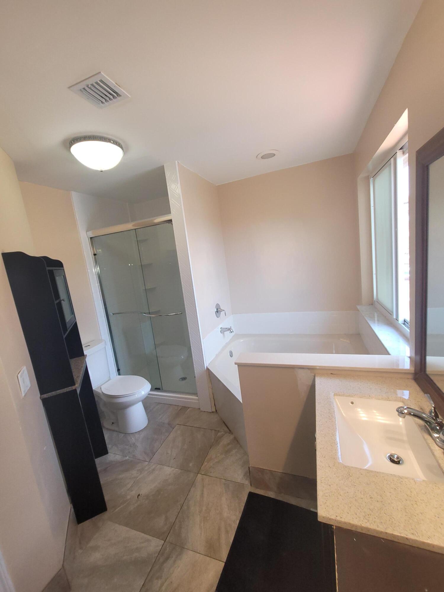 8448 Northwest 196th Terrace Hialeah, FL 33015 - Photo 19 of 67 a bathroom with a sink a toilet and tub