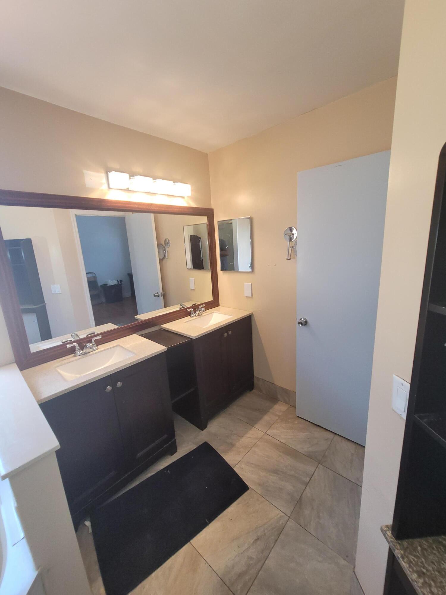 8448 Northwest 196th Terrace Hialeah, FL 33015 - Photo 20 of 67 a bedroom with a bed and mirror