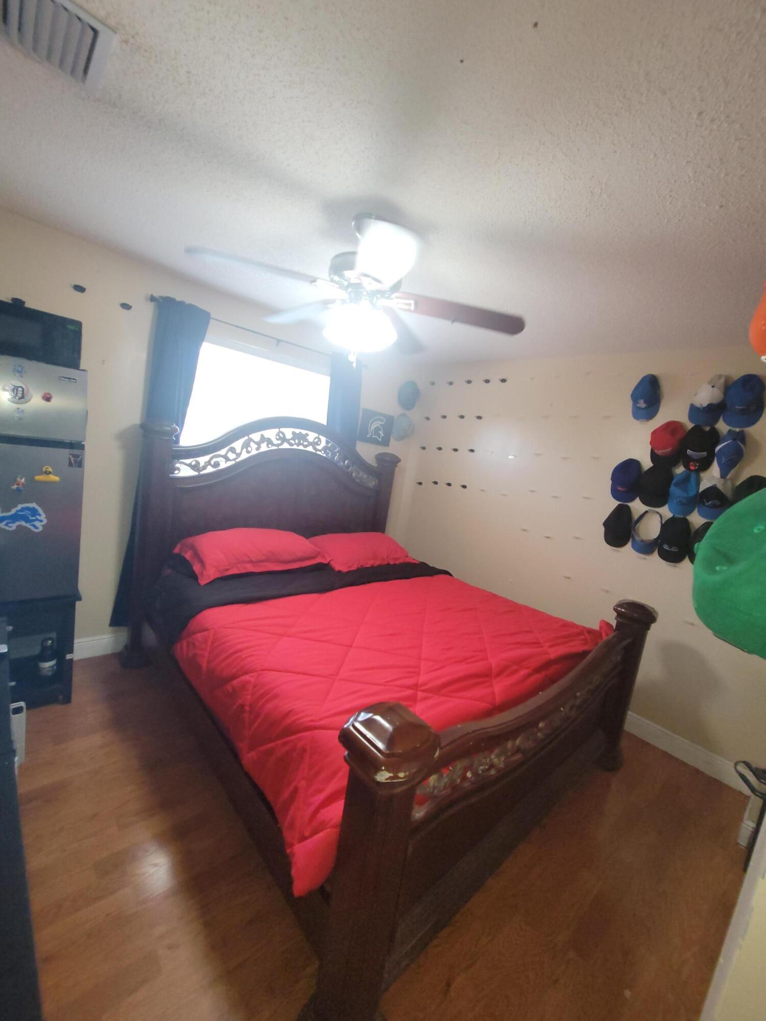 8448 Northwest 196th Terrace Hialeah, FL 33015 - Photo 21 of 67 a bedroom with a bed and a chandelier