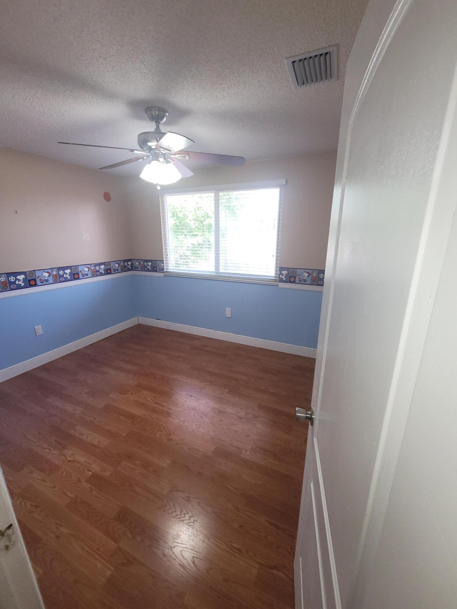 8448 Northwest 196th Terrace Hialeah, FL 33015 - Photo 22 of 67 wooden floor in an empty room with a window