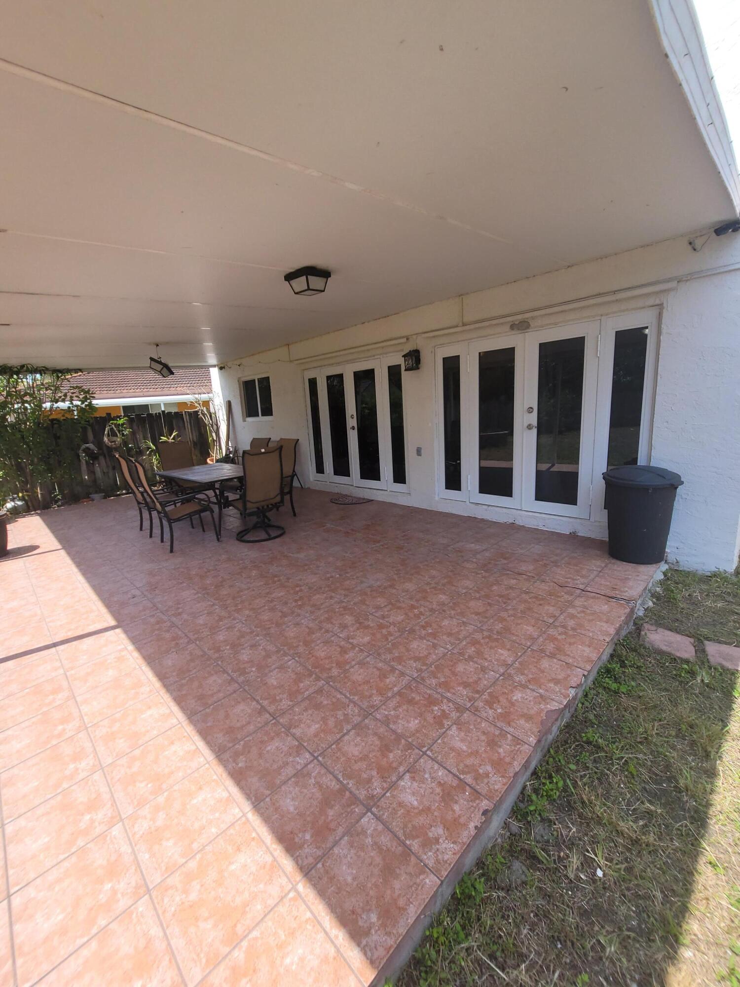 8448 Northwest 196th Terrace Hialeah, FL 33015 - Photo 29 of 67 a view of a patio with chair and tables