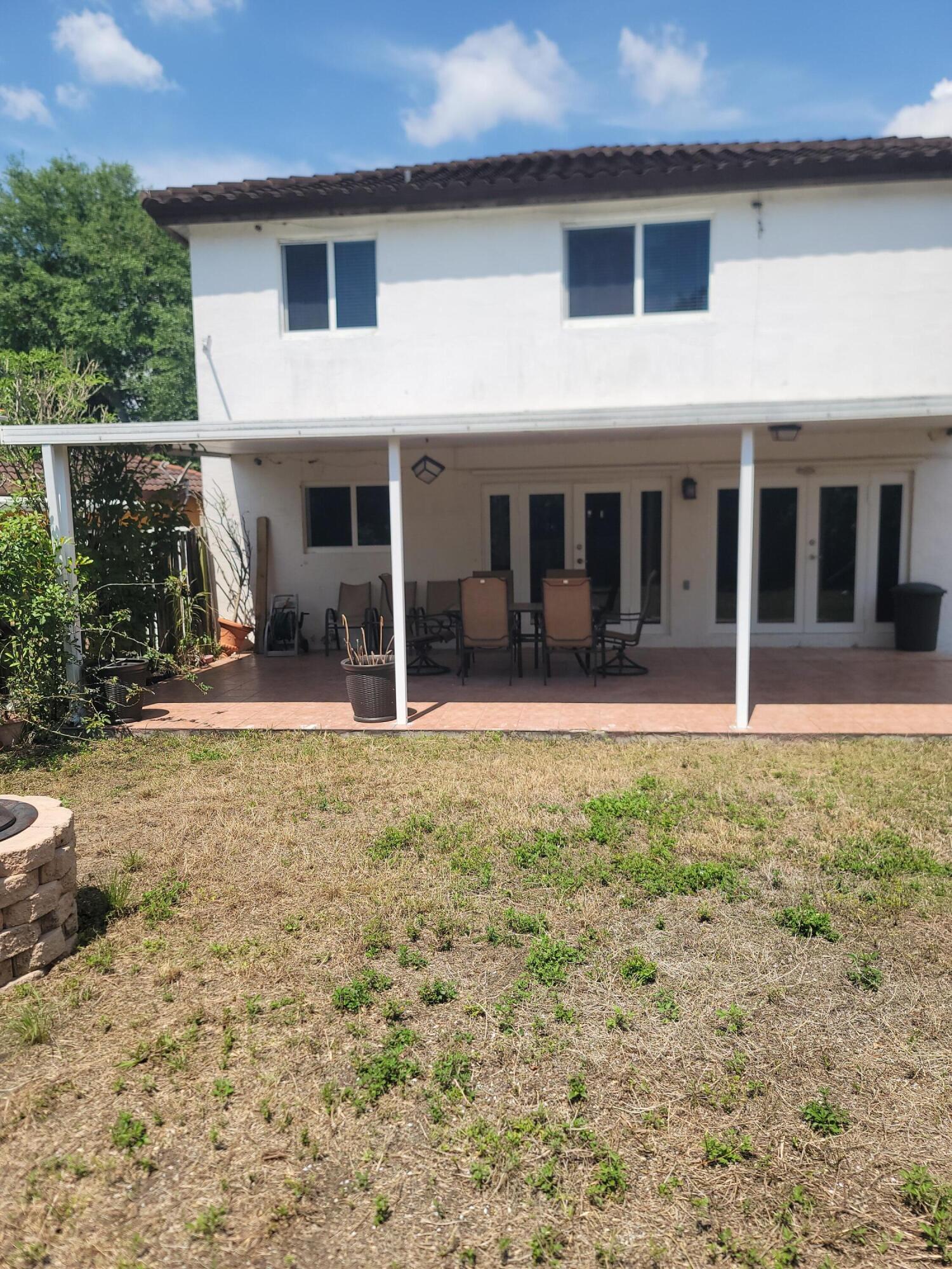 8448 Northwest 196th Terrace Hialeah, FL 33015 - Photo 33 of 67 a view of a house with backyard porch and sitting area