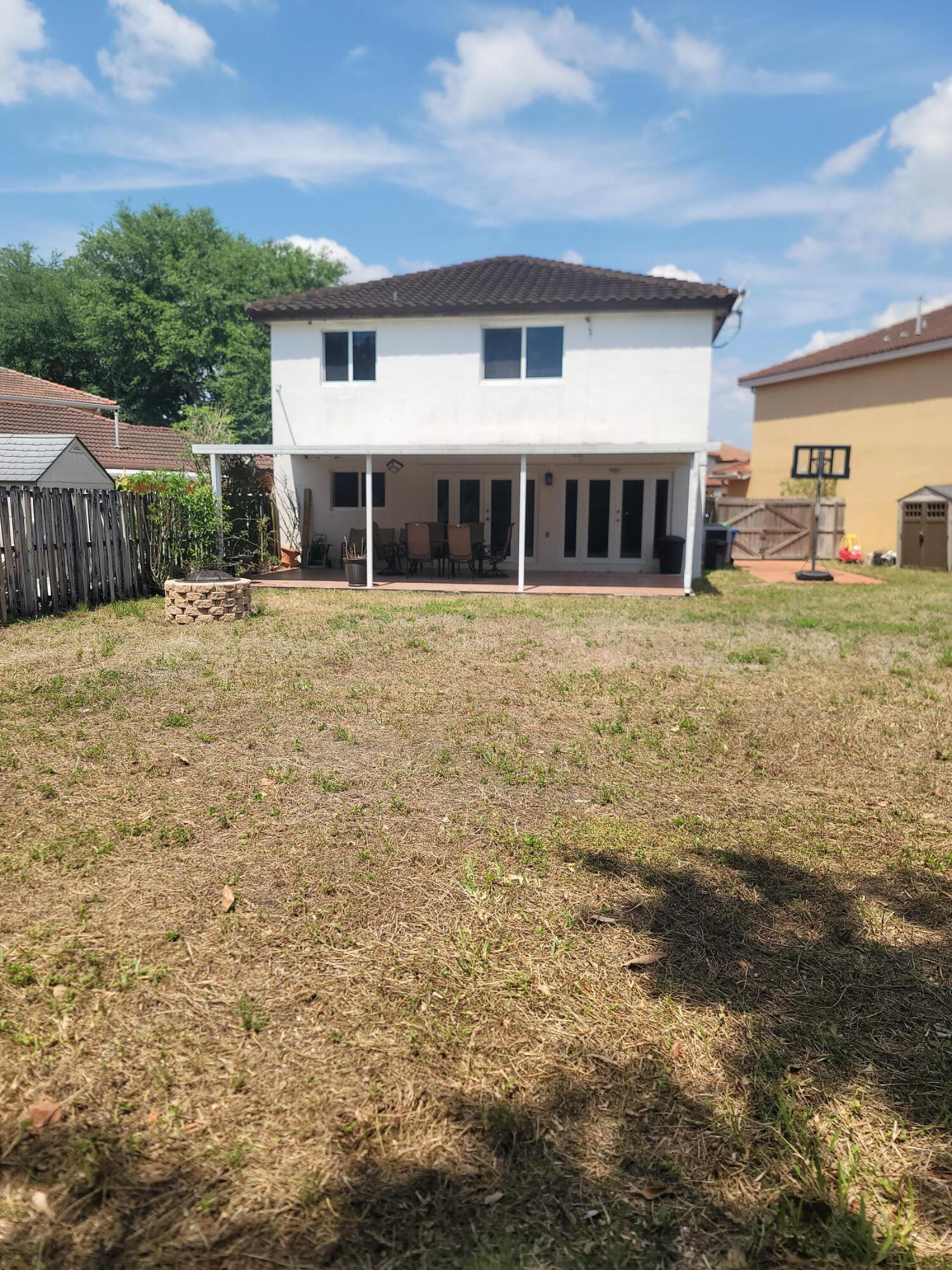 8448 Northwest 196th Terrace Hialeah, FL 33015 - Photo 34 of 67 a front view of a house with a garden