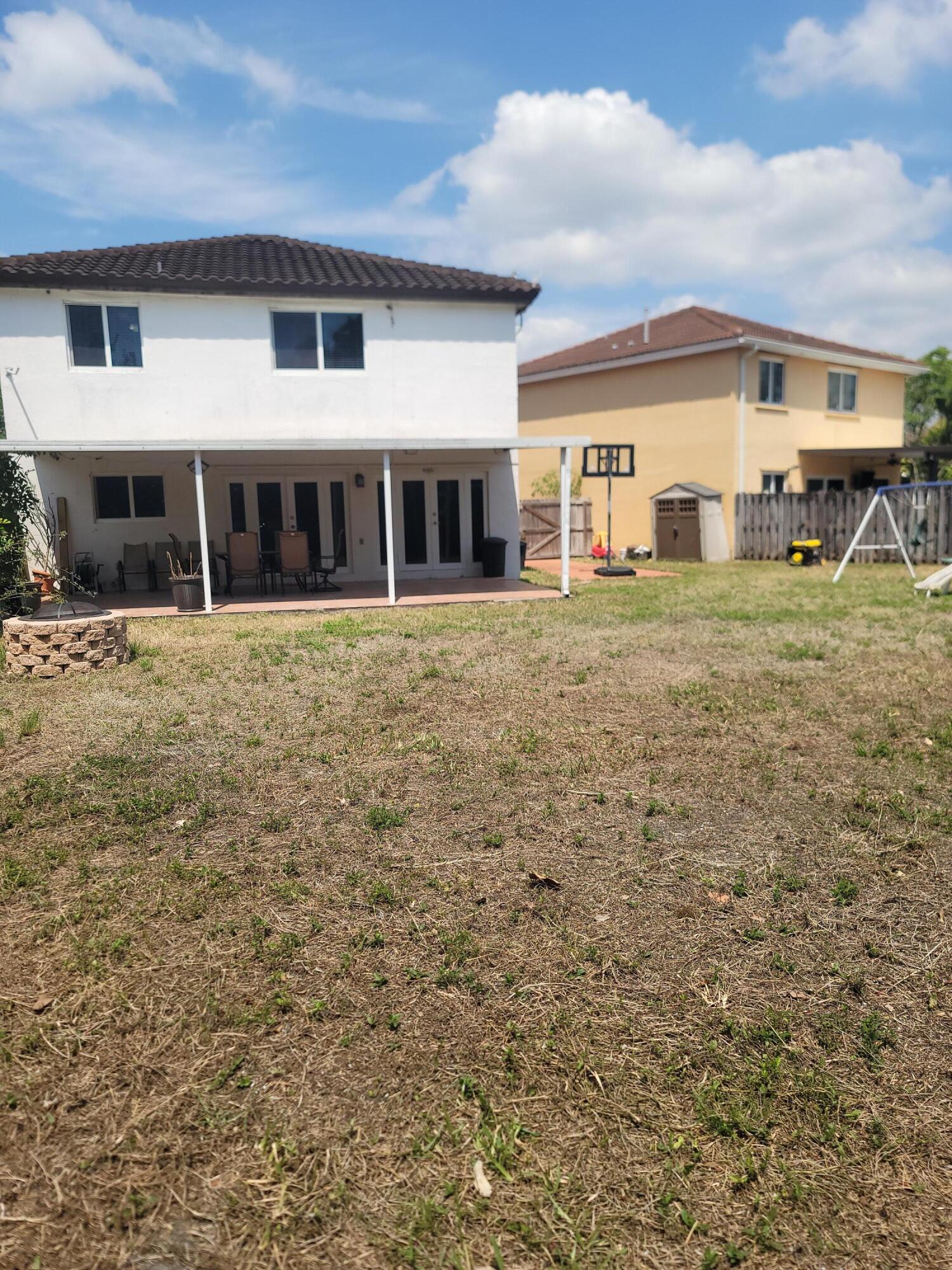 8448 Northwest 196th Terrace Hialeah, FL 33015 - Photo 36 of 67 a front view of a house with a garden