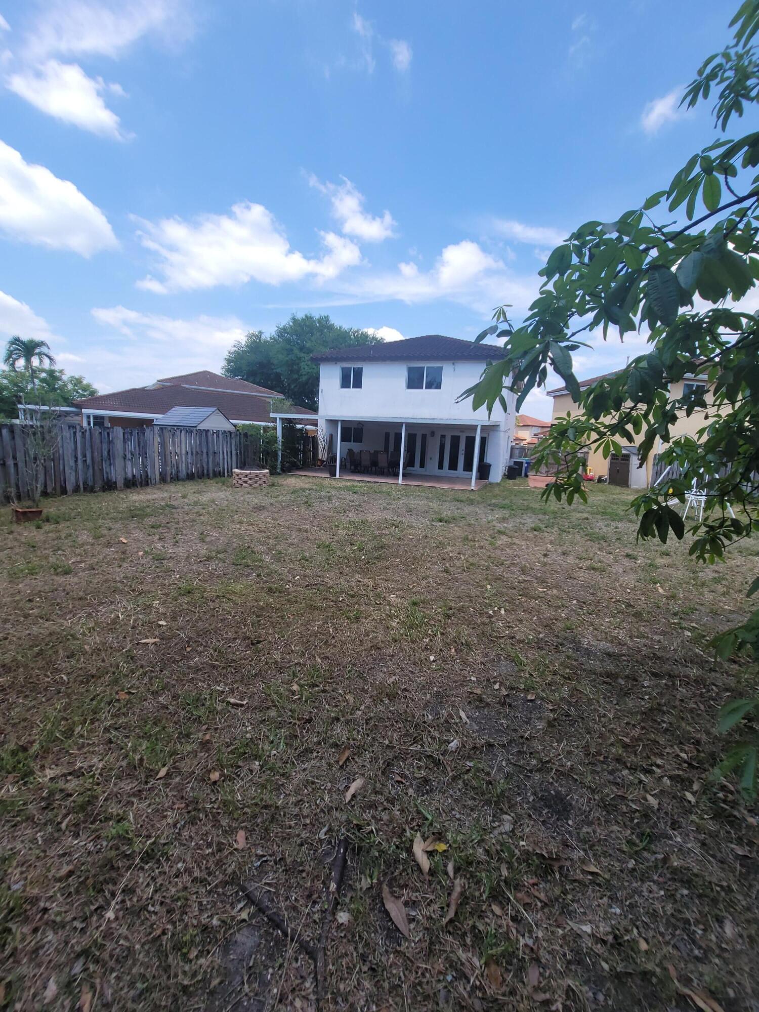 8448 Northwest 196th Terrace Hialeah, FL 33015 - Photo 38 of 67 a view of a big yard next to a house