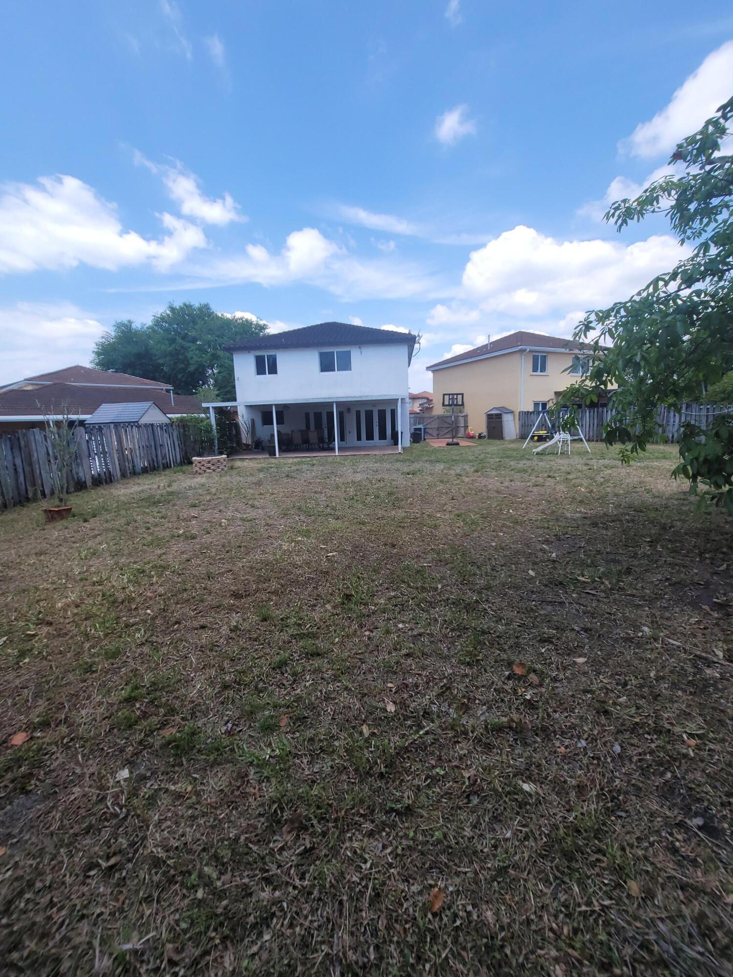 8448 Northwest 196th Terrace Hialeah, FL 33015 - Photo 39 of 67 a view of a house with a yard