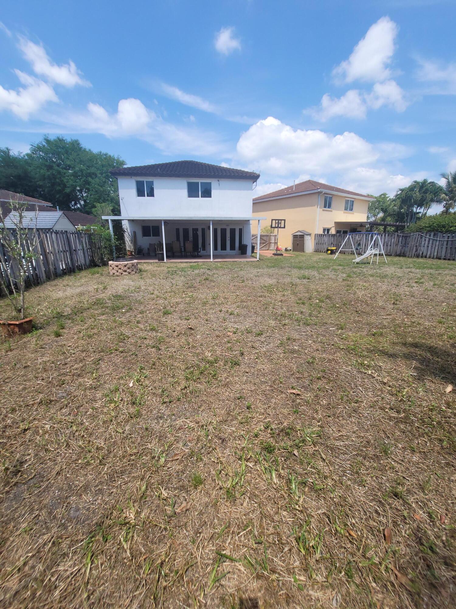 8448 Northwest 196th Terrace Hialeah, FL 33015 - Photo 41 of 67 a front view of a house with a yard
