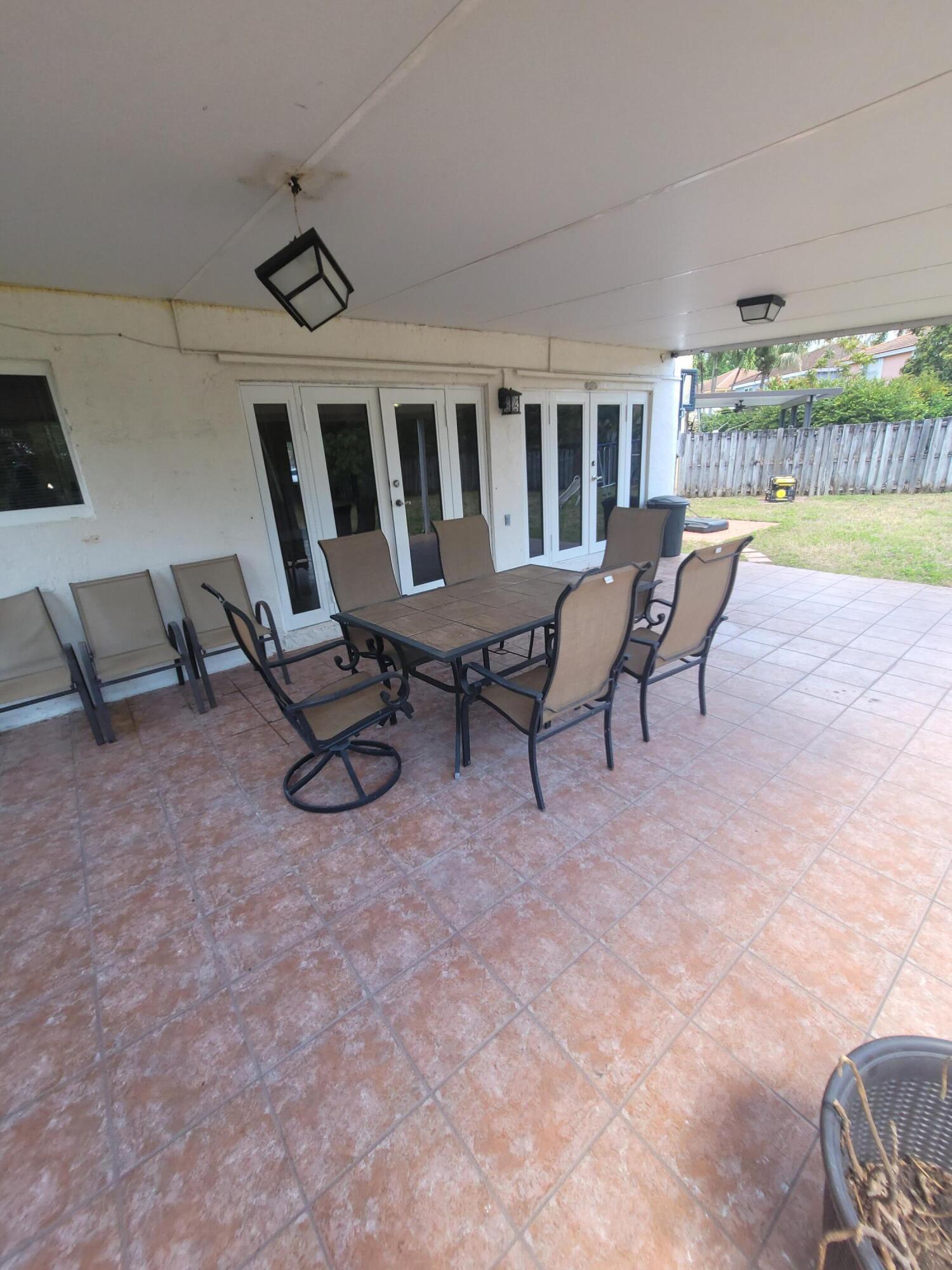 8448 Northwest 196th Terrace Hialeah, FL 33015 - Photo 51 of 67 a view of a chairs and table in the patio