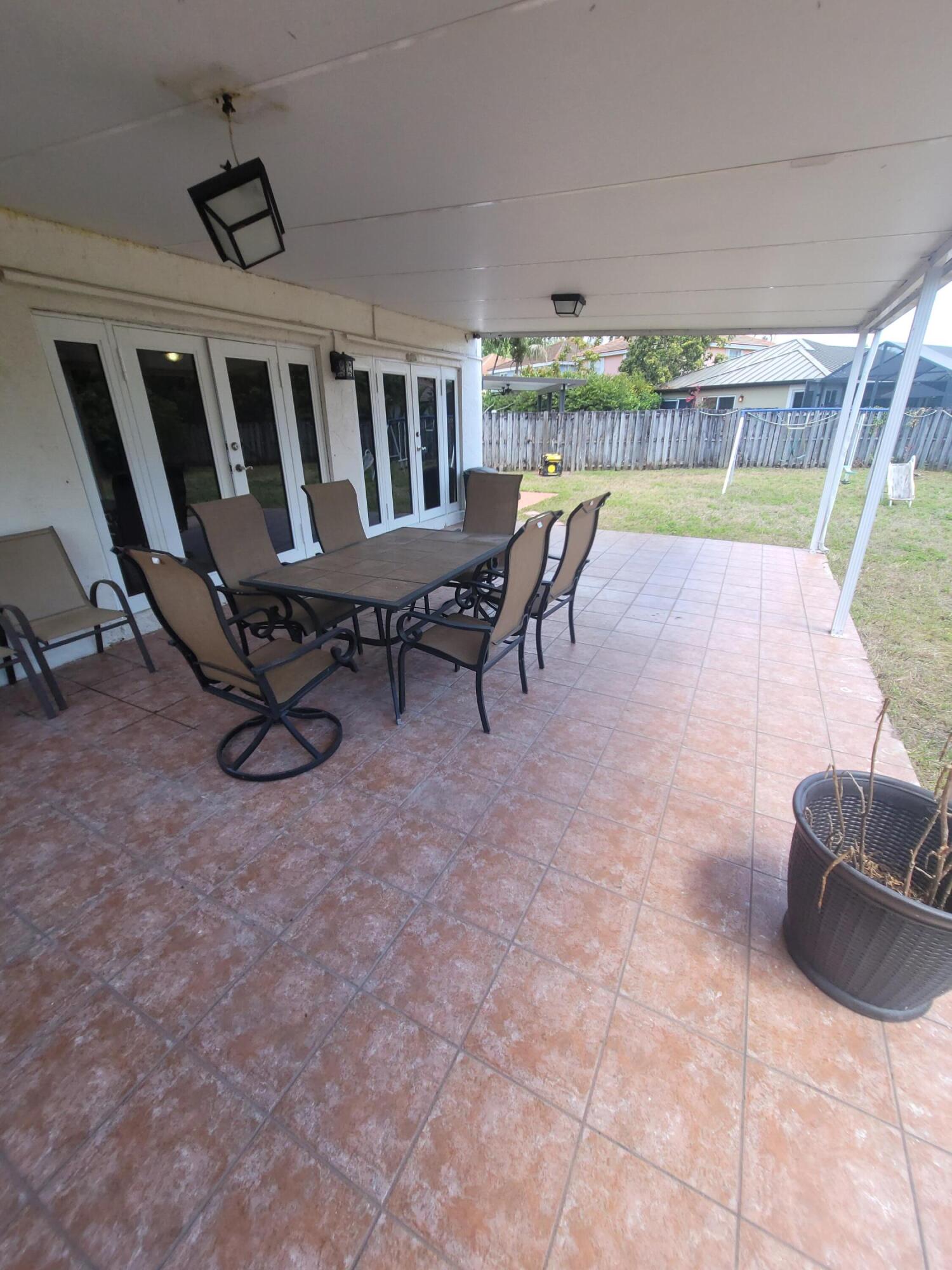 8448 Northwest 196th Terrace Hialeah, FL 33015 - Photo 52 of 67 a view of a chairs and table in patio