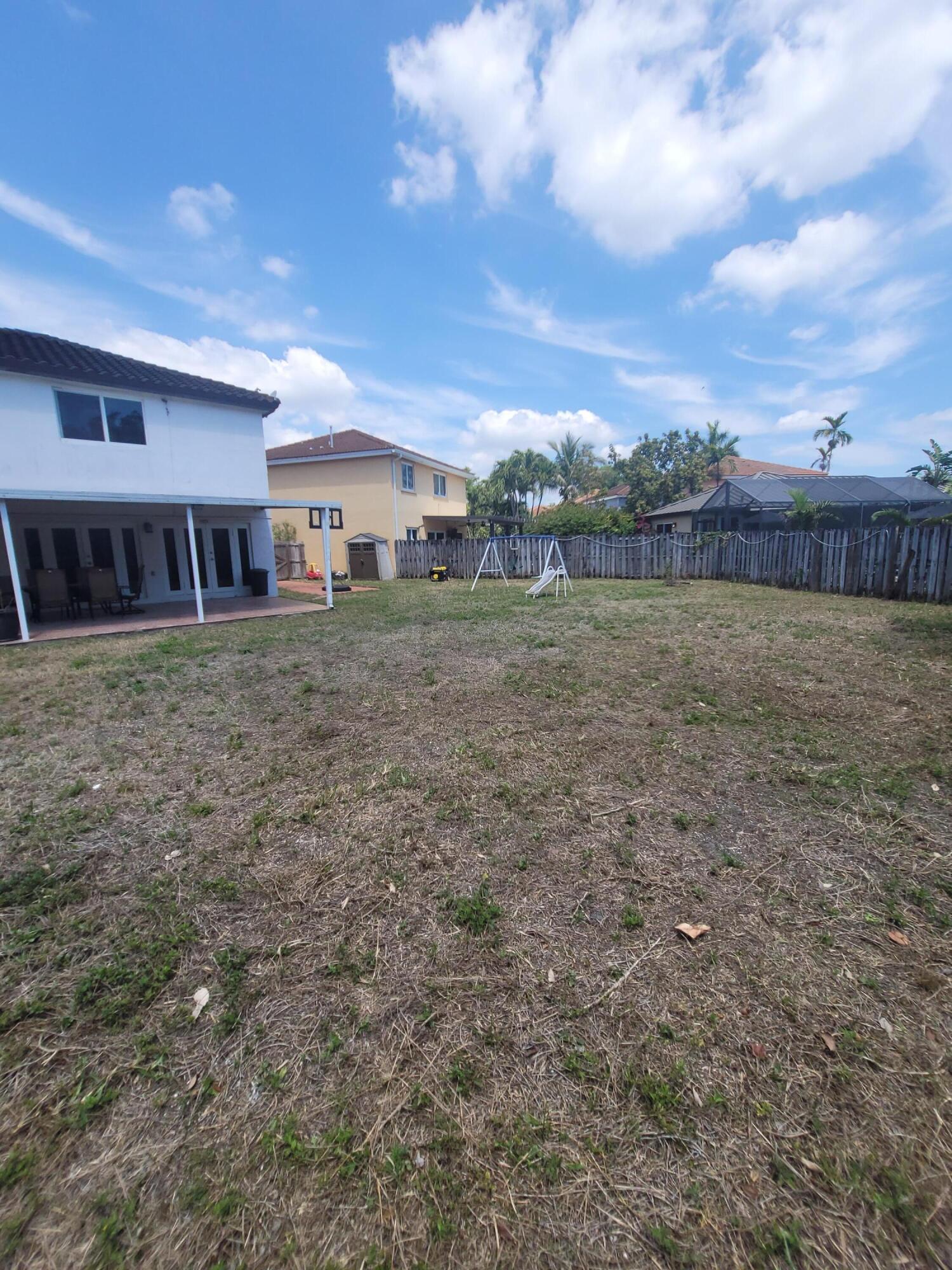 8448 Northwest 196th Terrace Hialeah, FL 33015 - Photo 54 of 67 a view of a house with a yard