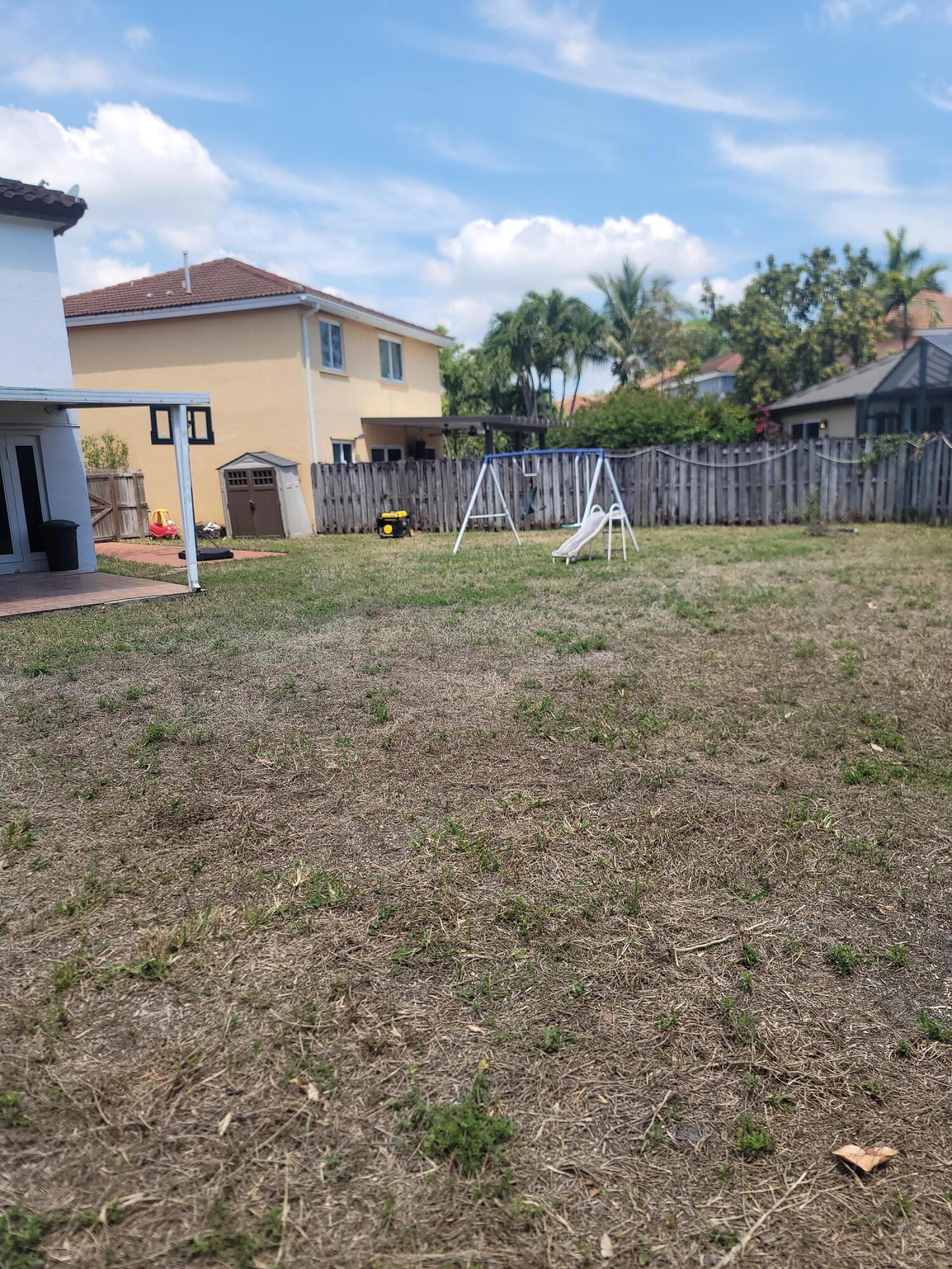8448 Northwest 196th Terrace Hialeah, FL 33015 - Photo 55 of 67 a view of a house with a yard and sitting area