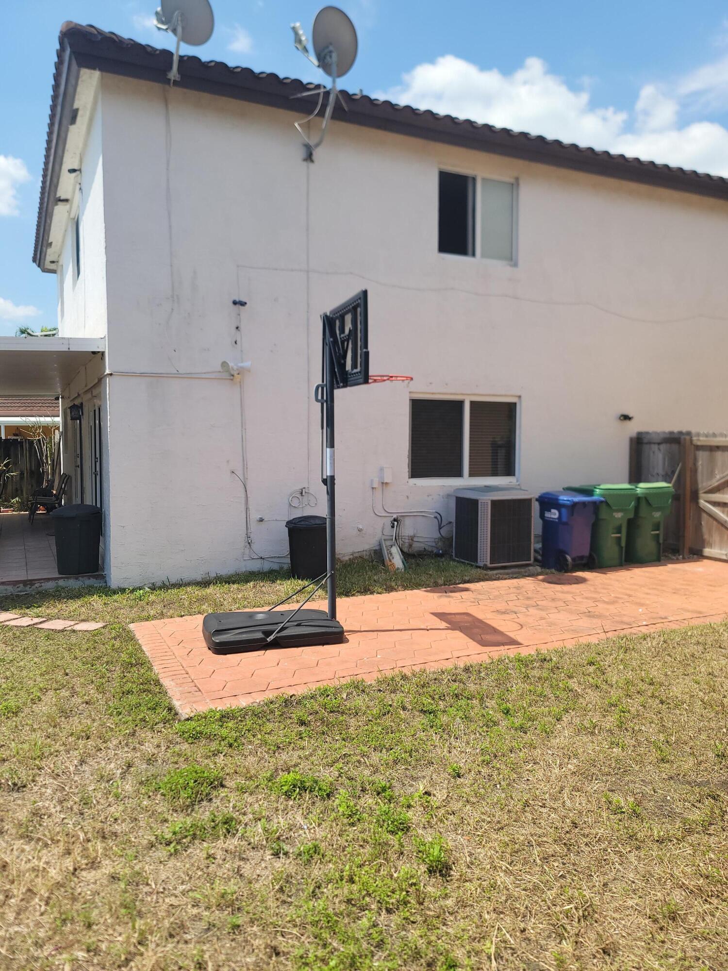 8448 Northwest 196th Terrace Hialeah, FL 33015 - Photo 57 of 67 a backyard of a house with seating space