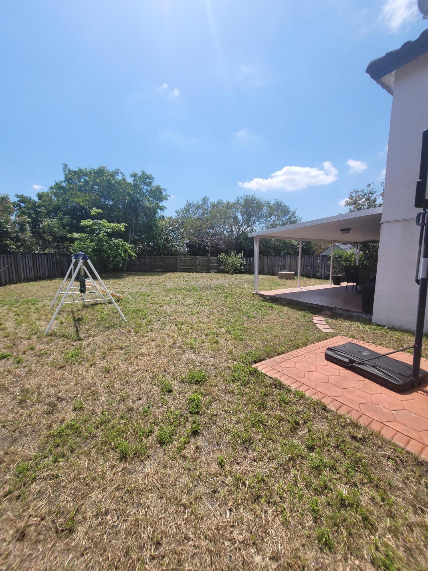 8448 Northwest 196th Terrace Hialeah, FL 33015 - Photo 61 of 67 a view of outdoor space with swimming pool and trees