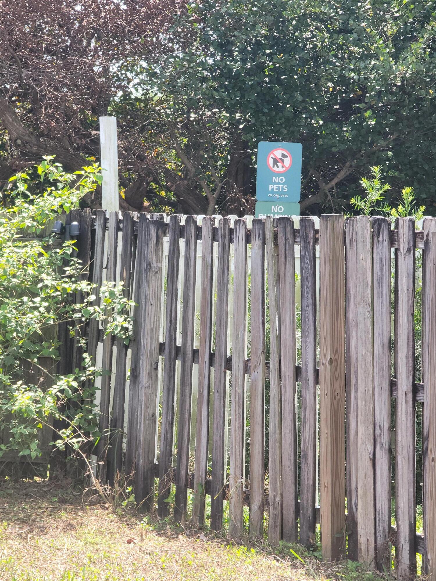 8448 Northwest 196th Terrace Hialeah, FL 33015 - Photo 63 of 67 a sign that is sitting in front of a wooden fence