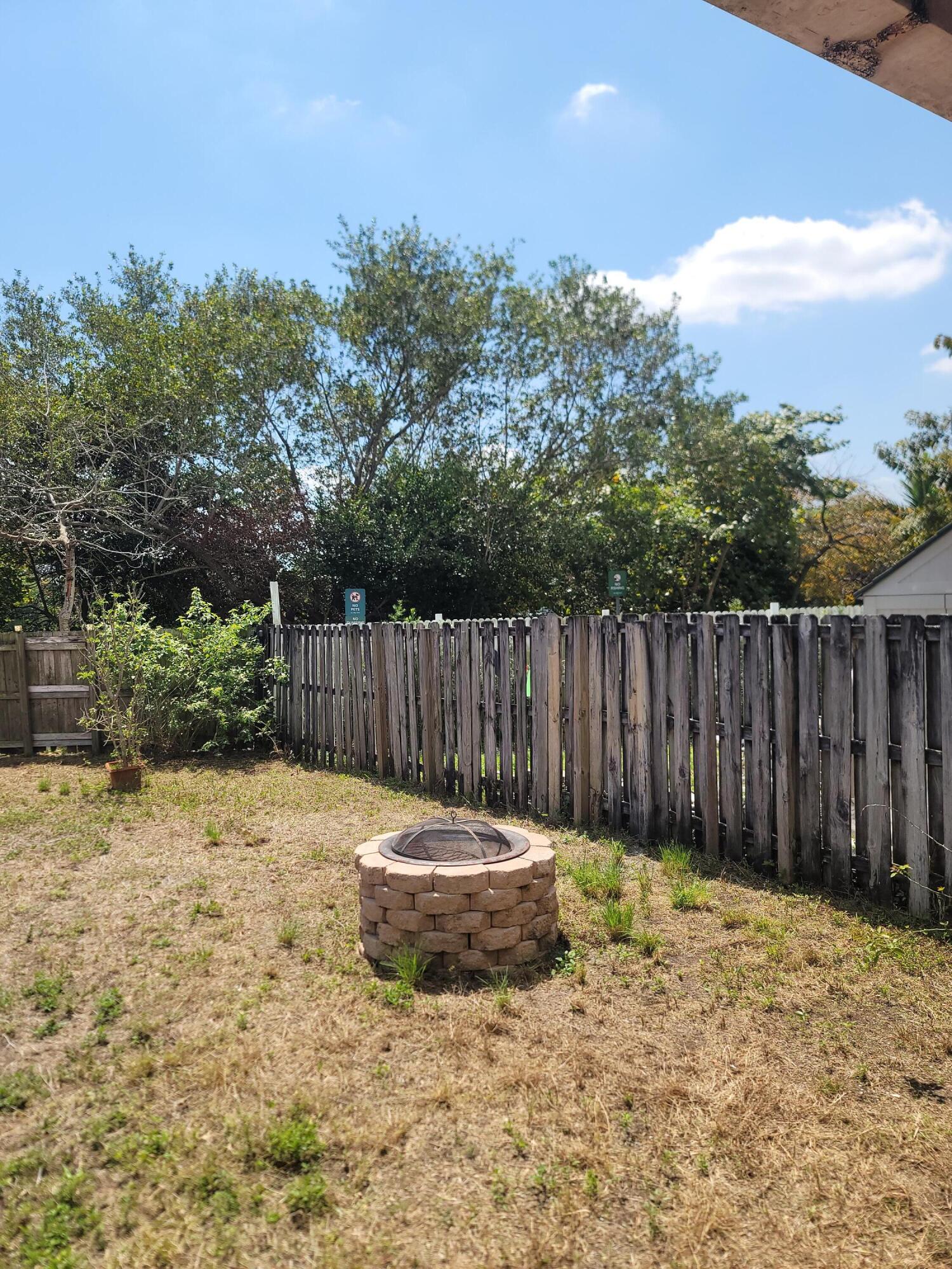 8448 Northwest 196th Terrace Hialeah, FL 33015 - Photo 65 of 67 a backyard of a house with table and chairs