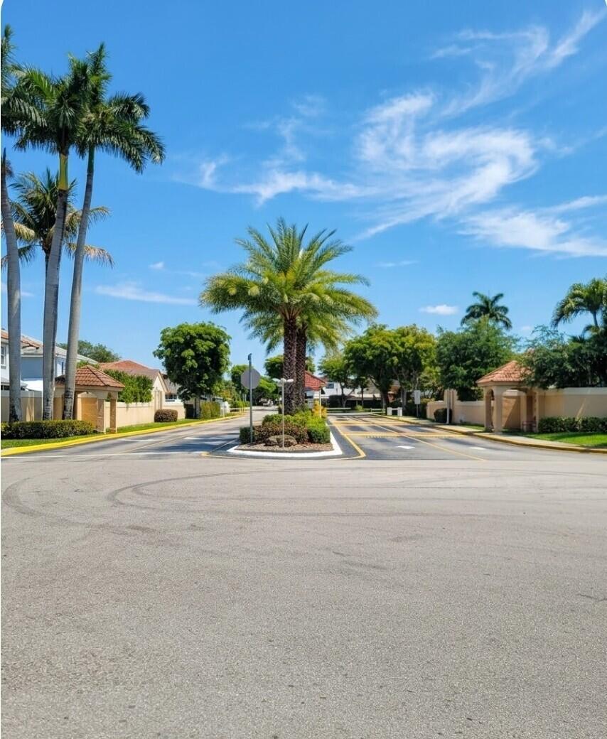 8448 Northwest 196th Terrace Hialeah, FL 33015 - Photo 67 of 67 a view of a street with a cars parked on the road