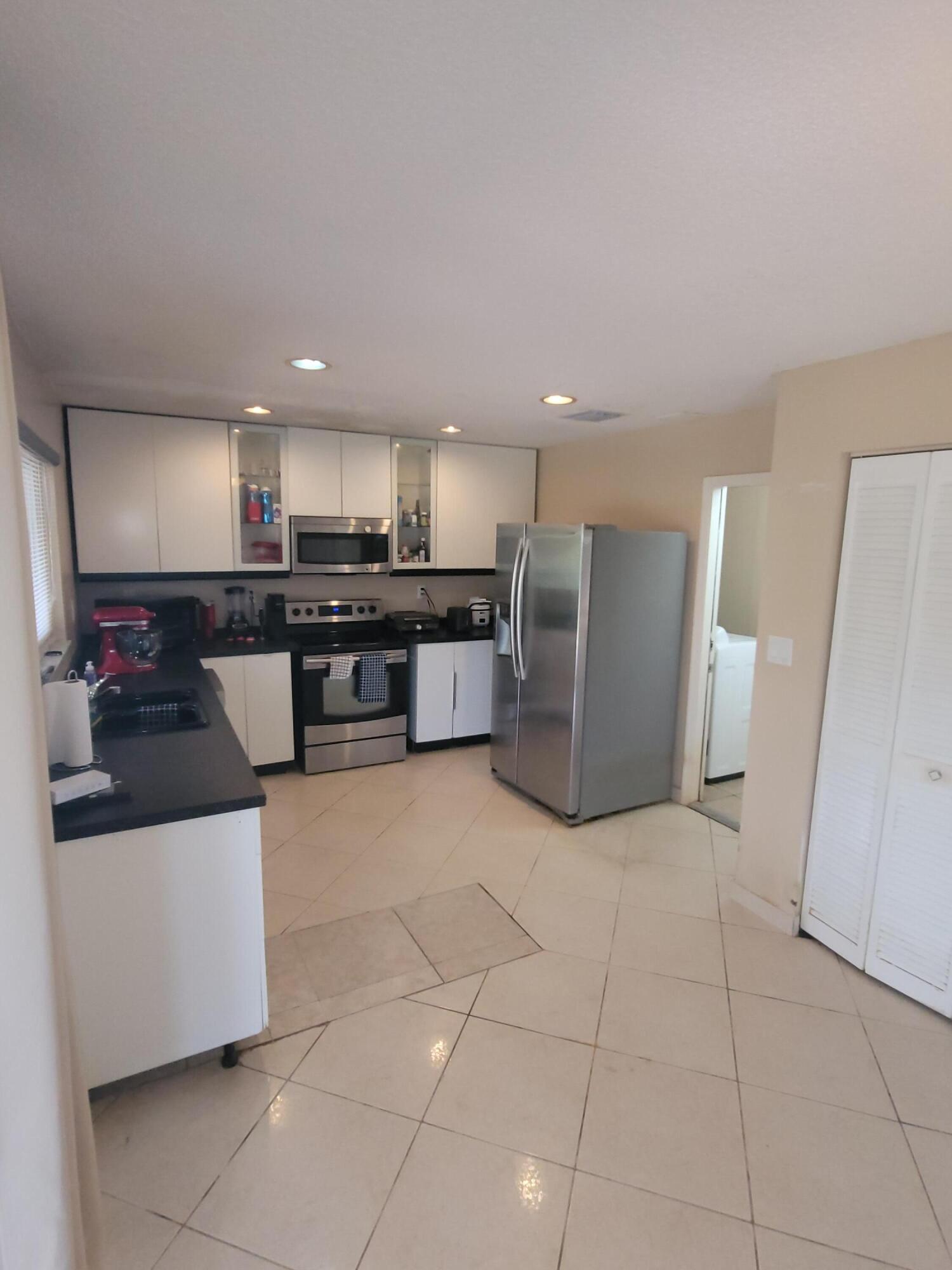 8448 Northwest 196th Terrace Hialeah, FL 33015 - Photo 10 of 67 a kitchen with stainless steel appliances granite countertop a refrigerator and a stove