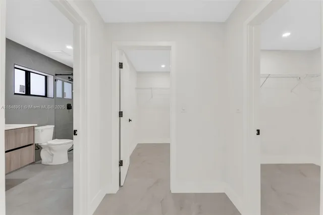 a bathroom with a toilet sink and shower