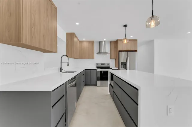 a kitchen with kitchen island a sink appliances and cabinets
