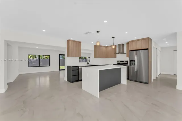 a large kitchen with cabinets and stainless steel appliances