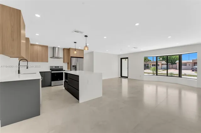 a kitchen with stainless steel appliances a refrigerator sink and cabinets