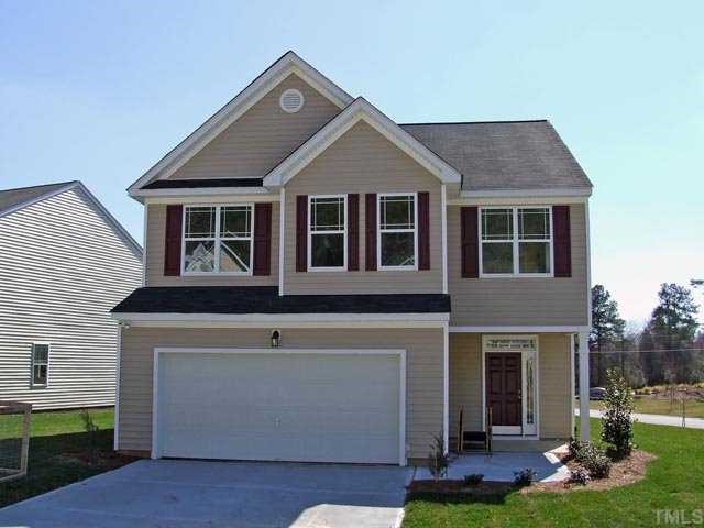 3620 Eastern Branch Road Raleigh, NC 27610 - Photo 2 of 3 a front view of a house with a yard and garage