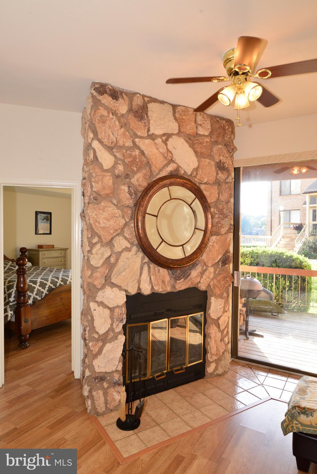 11220 Harbor Court, Unit 11220 Reston, VA 20191 - Photo 14 of 29 The wood-burning fireplace has a stone accent wall